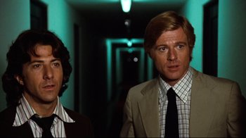 Movie still from “All the President's Men” (1976), directed by Alan J. Pakula – Two men standing in a dark hallway with lights on; Medium shot, Low angle