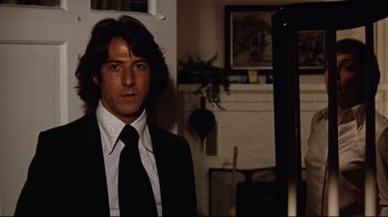 Movie still from “All the President's Men” (1976), directed by Alan J. Pakula – A man wearing a suit and tie in a room; Close Up shot, Over the shoulder angle