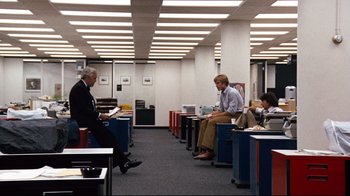 Movie still from “All the President's Men” (1976), directed by Alan J. Pakula – A group of people sitting in an office area; Wide shot, Over the shoulder angle