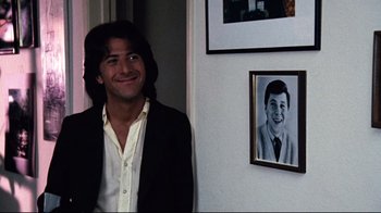Movie still from “All the President's Men” (1976), directed by Alan J. Pakula – A man standing in front of a picture of himself; Medium shot, Over the shoulder angle