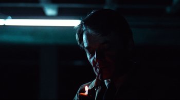 Movie still from “All the President's Men” (1976), directed by Alan J. Pakula – A man lighting a candle in a dark room; Close Up shot, Over the shoulder angle