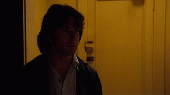 Movie still from “All the President's Men” (1976), directed by Alan J. Pakula – A man standing in front of a door in a room; Close Up shot, Low angle