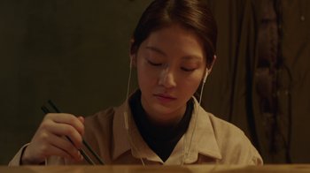 A woman wearing headphones and listening to music
