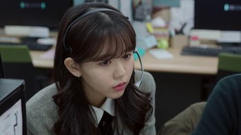 A woman wearing a headset sitting in an office