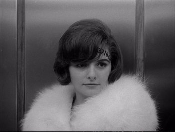 Movie still from “Alphaville” (1965), directed by Jean-Luc Godard – A black - and - white photo of a woman in a fur coat; Close Up shot, High angle