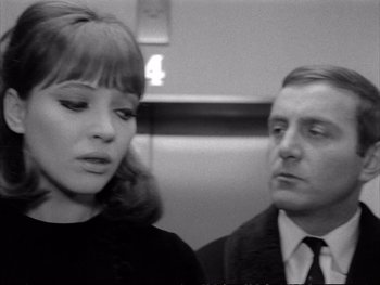 Movie still from “Alphaville” (1965), directed by Jean-Luc Godard – A man and a woman sitting next to each other on a train; Close Up shot, Low angle