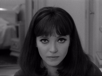 Movie still from “Alphaville” (1965), directed by Jean-Luc Godard – A black and white photo of a woman's face; Close Up shot, High angle