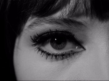 Movie still from “Alphaville” (1965), directed by Jean-Luc Godard – A woman's eye with long lashes; Extreme Close Up shot, Overhead angle