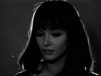 Movie still from “Alphaville” (1965), directed by Jean-Luc Godard – A black - and - white photo of a woman's face; Close Up shot, High angle