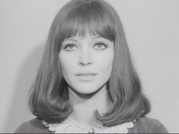 Movie still from “Alphaville” (1965), directed by Jean-Luc Godard – A black and white photo of a woman's face; Close Up shot, Low angle