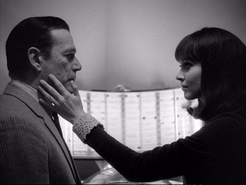 Movie still from “Alphaville” (1965), directed by Jean-Luc Godard – A man and a woman touching each other's face; Close Up shot, Low angle