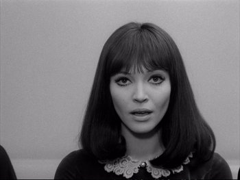 Movie still from “Alphaville” (1965), directed by Jean-Luc Godard – Black and white photograph of a young woman with long hair; Close Up shot, Over the shoulder angle