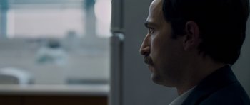 Movie still from “Alps” (2011), directed by Yorgos Lanthimos – A person looking to his left; Close Up shot, Over the shoulder angle