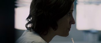 Movie still from “Alps” (2011), directed by Yorgos Lanthimos – A person's face with a phone in her hand; Extreme Close Up shot, Low angle