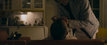 Movie still from “Alps” (2011), directed by Yorgos Lanthimos – A woman is giving a man a hair cut; Extreme Close Up shot, Over the shoulder angle