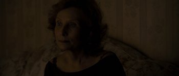 Movie still from “Alps” (2011), directed by Yorgos Lanthimos – A person in a dark room; Close Up shot, High angle