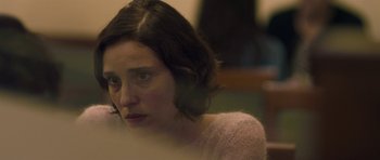 Movie still from “Alps” (2011), directed by Yorgos Lanthimos – A person sitting in front of a window; Close Up shot, Over the shoulder angle