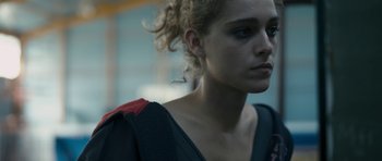 Movie still from “Alps” (2011), directed by Yorgos Lanthimos – A person with curly hair; Close Up shot, Over the shoulder angle