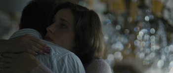Movie still from “Alps” (2011), directed by Yorgos Lanthimos – A woman's face as she rests her head on a man's shoulder; Close Up shot, Over the shoulder angle