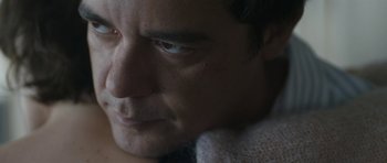 Movie still from “Alps” (2011), directed by Yorgos Lanthimos – A man's face with a towel around his neck; Extreme Close Up shot, Low angle
