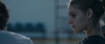 Movie still from “Alps” (2011), directed by Yorgos Lanthimos – A woman's face in a parking lot; Close Up shot, Over the shoulder angle