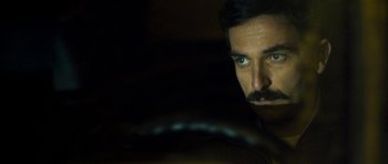 Movie still from “Alps” (2011), directed by Yorgos Lanthimos – A person with a mustache; Close Up shot, Over the shoulder angle