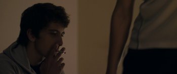 Movie still from “Alps” (2011), directed by Yorgos Lanthimos – A man smoking a cigarette in front of a mirror; Close Up shot, Over the shoulder angle