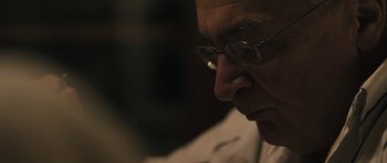 Movie still from “Alps” (2011), directed by Yorgos Lanthimos – A person wearing glasses; Close Up shot, Low angle