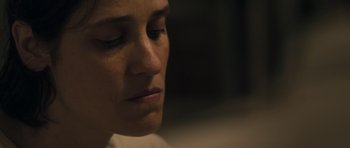 Movie still from “Alps” (2011), directed by Yorgos Lanthimos – A woman's face in the dark; Close Up shot, High angle