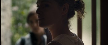 Movie still from “Alps” (2011), directed by Yorgos Lanthimos – A woman's face in the sunlight; Close Up shot, Over the shoulder angle