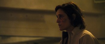Movie still from “Alps” (2011), directed by Yorgos Lanthimos – A woman with a face paint looking to her left; Close Up shot, Over the shoulder angle