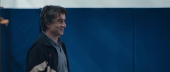 Movie still from “Alps” (2011), directed by Yorgos Lanthimos – A person wearing a jacket; Medium shot, Low angle