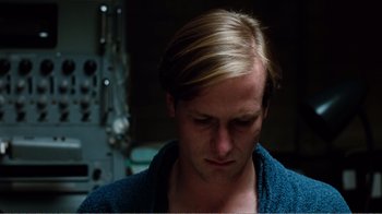 Movie still from “Altered States” (1980), directed by Ken Russell – A person wearing a blue shirt; Close Up shot, High angle