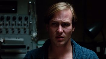 Movie still from “Altered States” (1980), directed by Ken Russell – A person wearing a blue shirt; Close Up shot, Low angle
