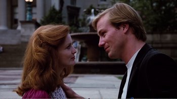 Movie still from “Altered States” (1980), directed by Ken Russell – A man and a woman standing next to each other on a sidewalk; Close Up shot, Low angle