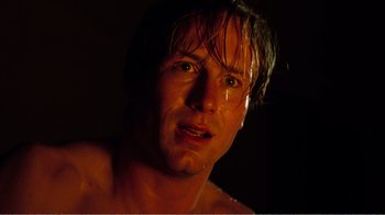 Movie still from “Altered States” (1980), directed by Ken Russell – A person in a dark room; Close Up shot, Low angle