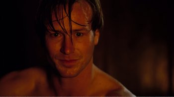 Movie still from “Altered States” (1980), directed by Ken Russell – A shirtless man with wet hair; Close Up shot, High angle