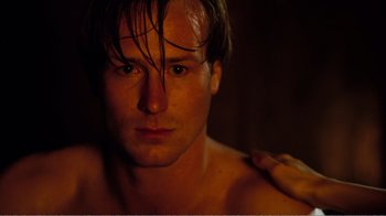 Movie still from “Altered States” (1980), directed by Ken Russell – A person with his eyes closed; Close Up shot, Over the shoulder angle