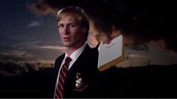 Movie still from “Altered States” (1980), directed by Ken Russell – A man in a suit holding a piece of paper; Close Up shot, Low angle