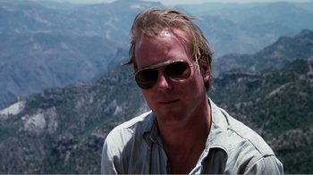 Movie still from “Altered States” (1980), directed by Ken Russell – A person wearing sunglasses on top of a mountain; Close Up shot, Low angle