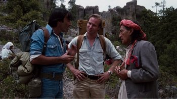 Movie still from “Altered States” (1980), directed by Ken Russell – A group of men standing next to each other on top of a hill; Medium shot, Over the shoulder angle