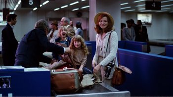 Movie still from “Altered States” (1980), directed by Ken Russell – A group of people at an airport waiting for their luggage; Wide shot, High angle
