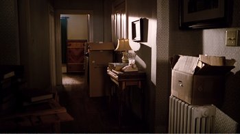 Movie still from “Altered States” (1980), directed by Ken Russell – A room filled with furniture and a lamp on a table; Wide shot, High angle