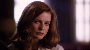 Movie still from “Altered States” (1980), directed by Ken Russell – A person with long red hair; Close Up shot, Low angle