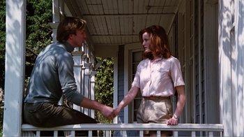 Movie still from “Altered States” (1980), directed by Ken Russell – A man and a woman shaking hands on a porch; Medium shot, Low angle