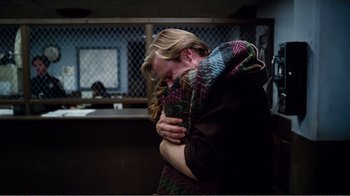 Movie still from “Altered States” (1980), directed by Ken Russell – A woman hugging another woman in a room; Medium shot, Over the shoulder angle