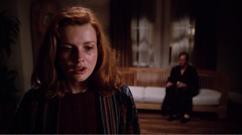 Movie still from “Altered States” (1980), directed by Ken Russell – A woman with red hair is looking at the camera; Medium shot, Over the shoulder angle