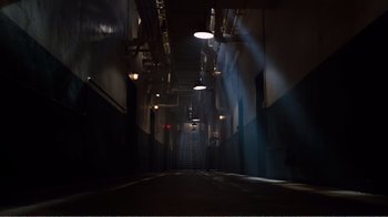 Movie still from “Altered States” (1980), directed by Ken Russell – A dark alley way with lights shining on it; Extreme Wide shot, High angle