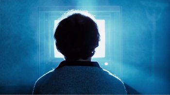 Movie still from “Altered States” (1980), directed by Ken Russell – A person is looking out a window at the light; Close Up shot, Over the shoulder angle