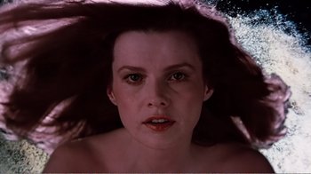 Movie still from “Altered States” (1980), directed by Ken Russell – A person with long brown hair; Close Up shot, Overhead angle